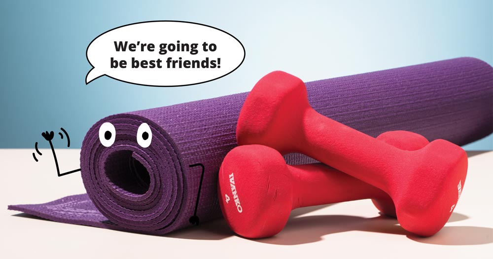 Hand weights and a yoga mat that says: We're going to be best friends!